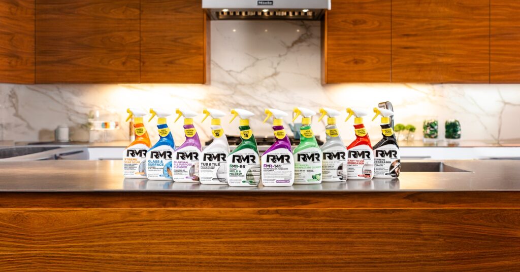 A line of RMR cleaning product bottles on a kitchen counter.