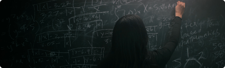 Woman solving complex math problems on chalkboard filled with equations and formulas
