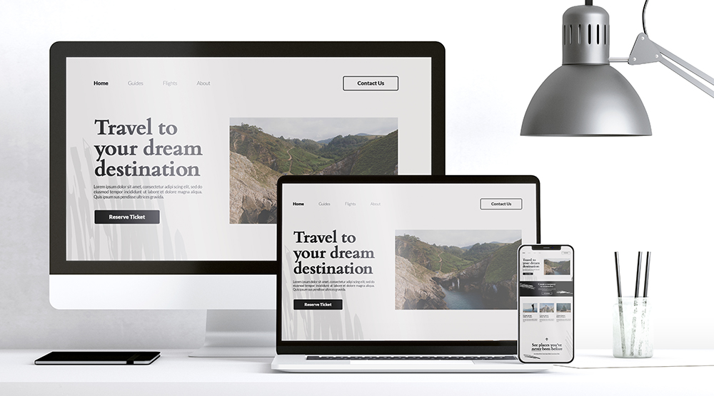 Responsive travel website design shown on desktop, laptop, and mobile screen
