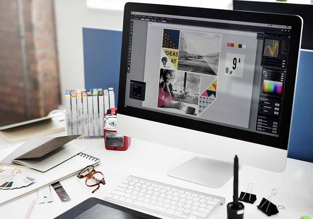 Creative design workspace with digital artwork open on iMac screen