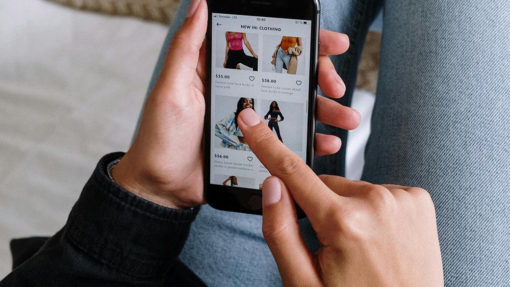 Person using smartphone to shop fashion items through an online store app